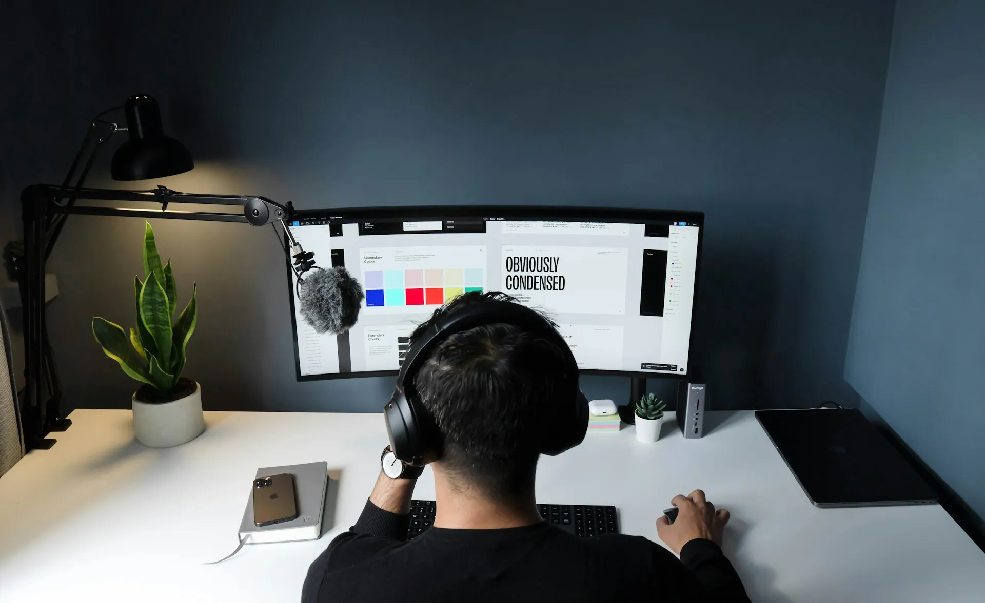 A man sitting at a desk using a computer.